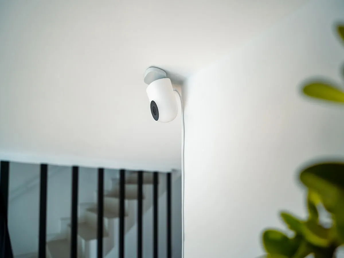White smart security camera neatly installed inside a modern home
